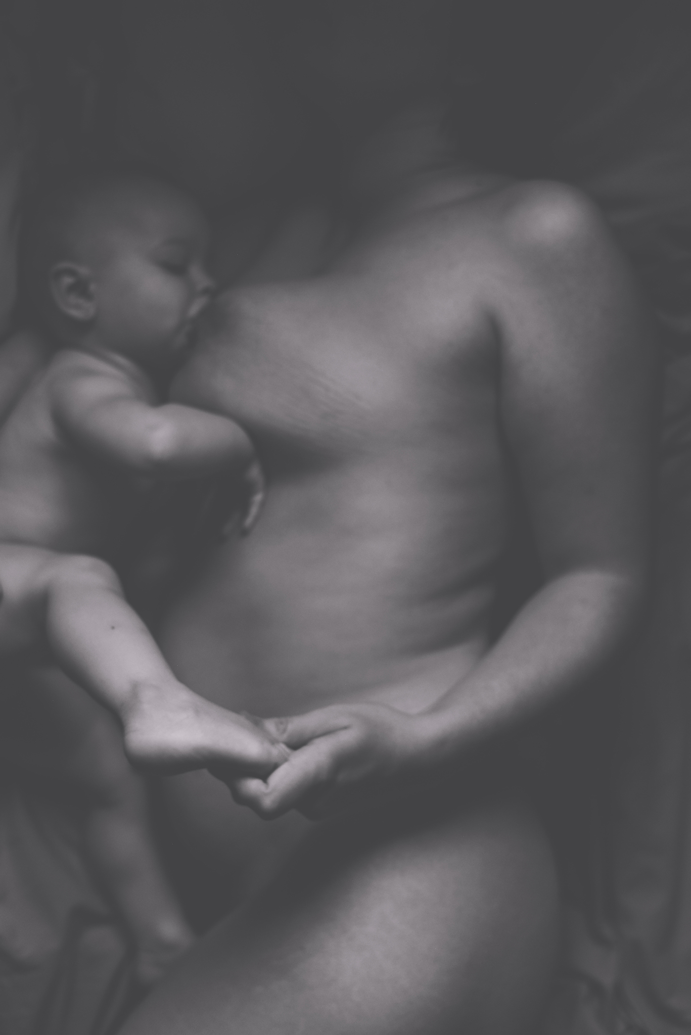 mother and baby breastfeeding in bed