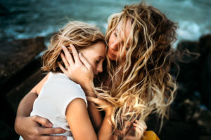 mother with hands on childs face